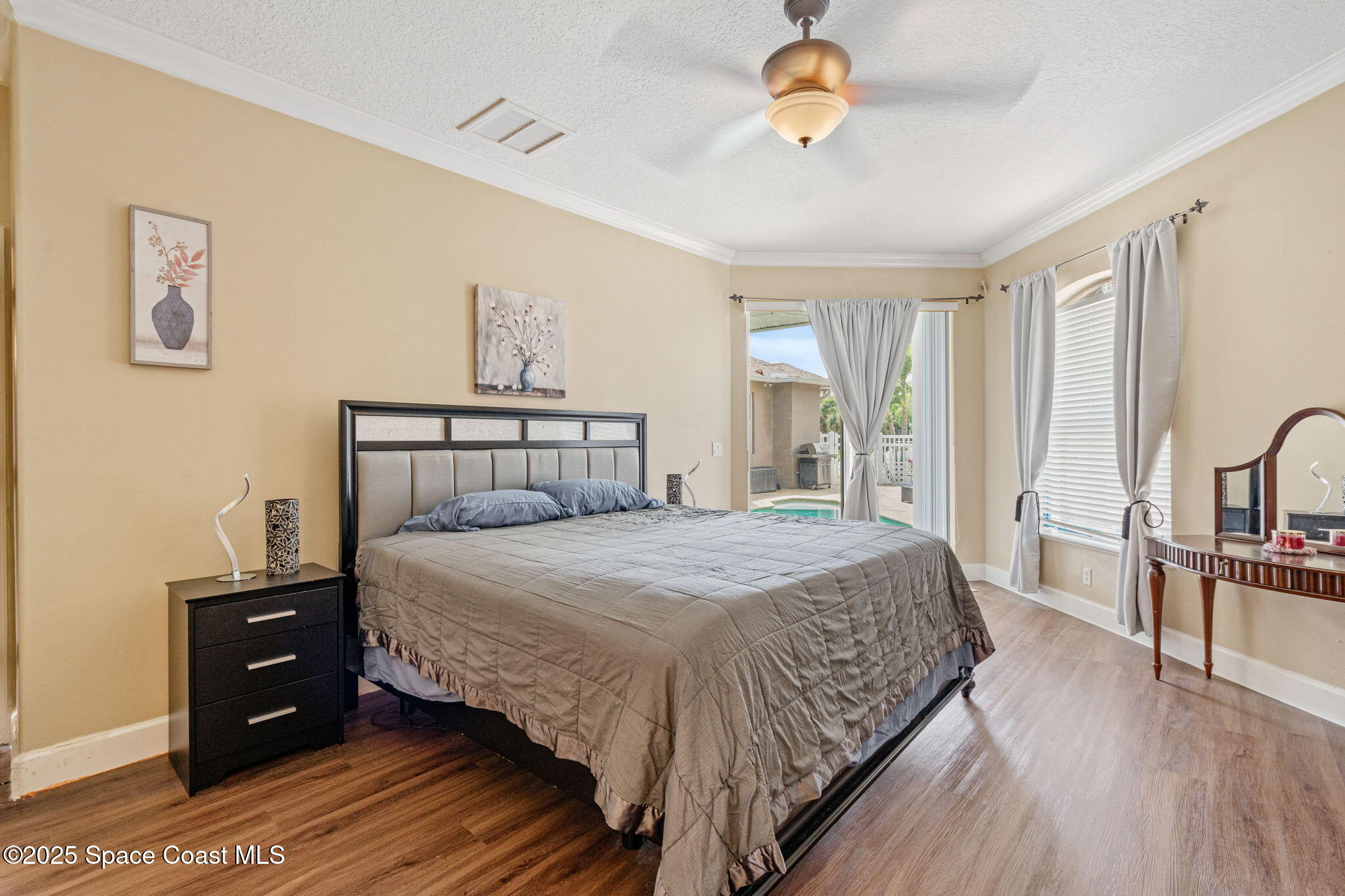 1835 Harbor Point Drive Merritt Island, FL 32952 - Photo 12 of 67 a bedroom with a bed and a chandelier