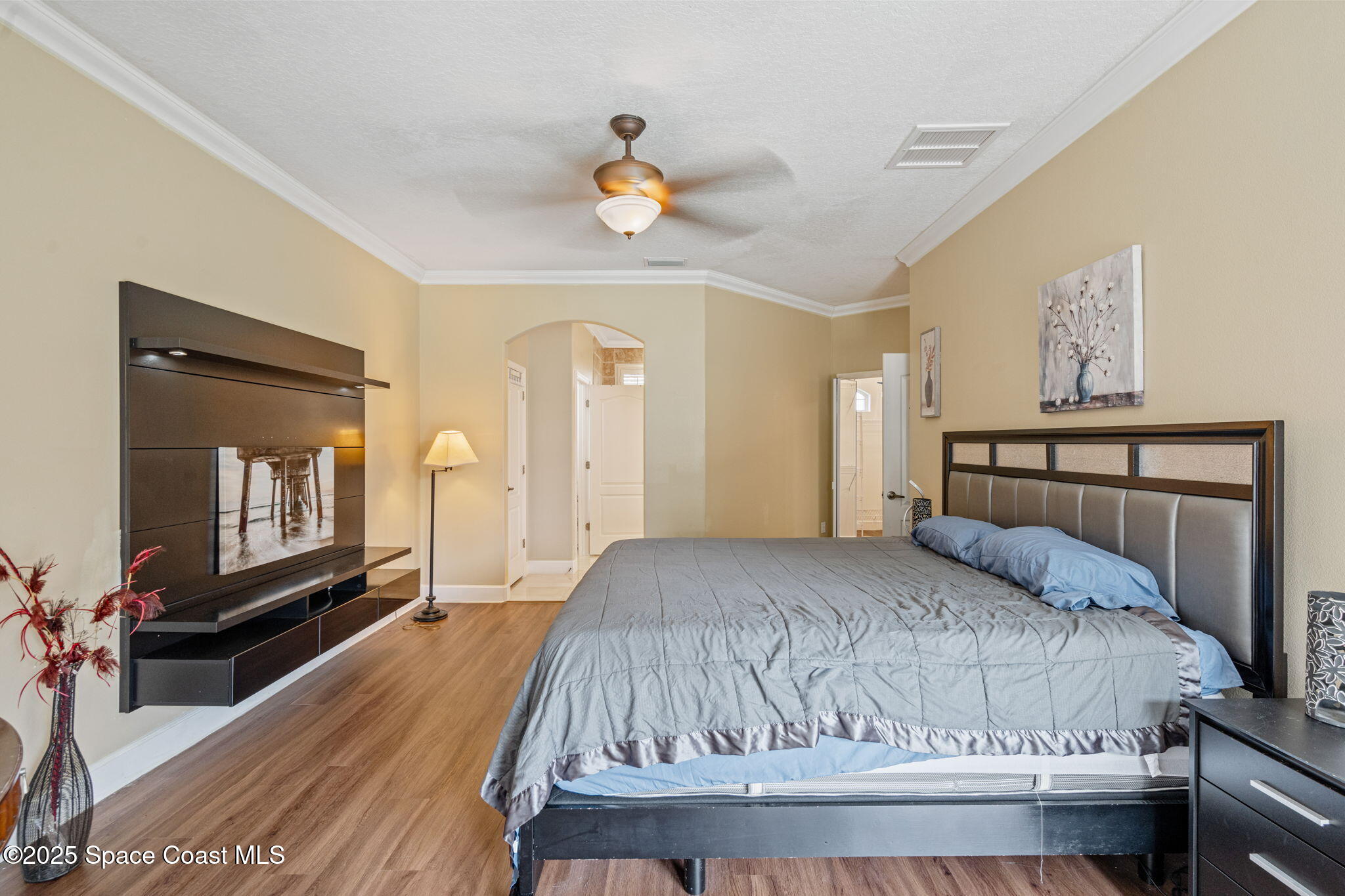 1835 Harbor Point Drive Merritt Island, FL 32952 - Photo 13 of 67 a bedroom with a large bed and a chandelier