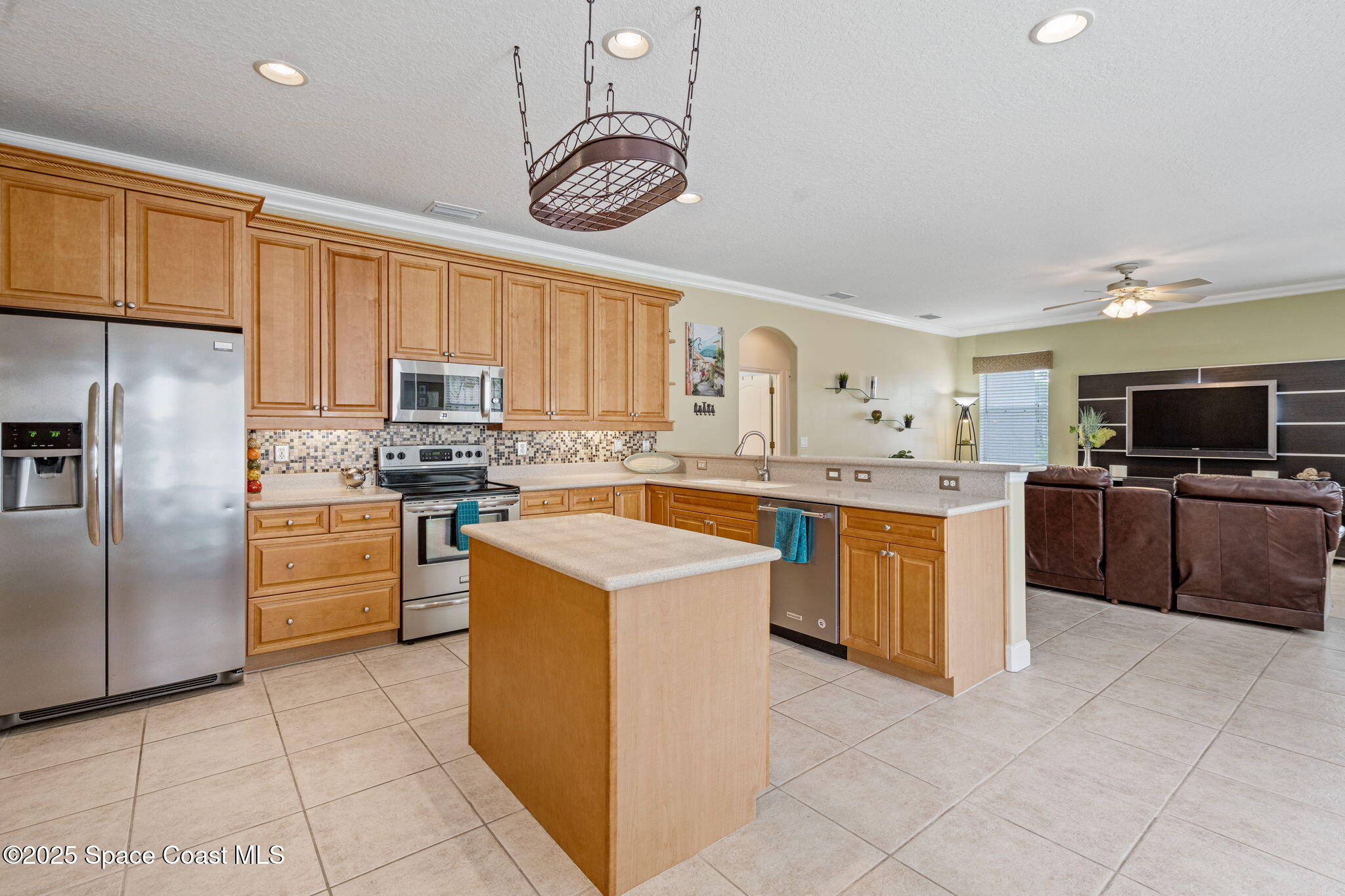 1835 Harbor Point Drive Merritt Island, FL 32952 - Photo 27 of 67 a kitchen with cabinets and stainless steel appliances