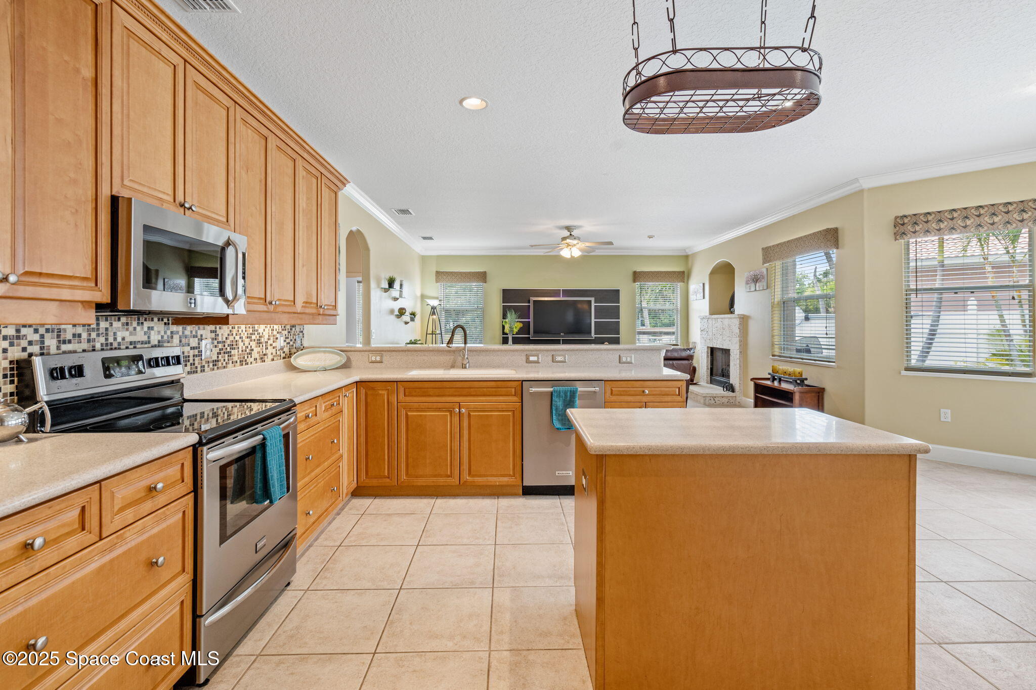 1835 Harbor Point Drive Merritt Island, FL 32952 - Photo 28 of 67 a large kitchen with stainless steel appliances granite countertop a stove top oven a sink a stove and a refrigerator
