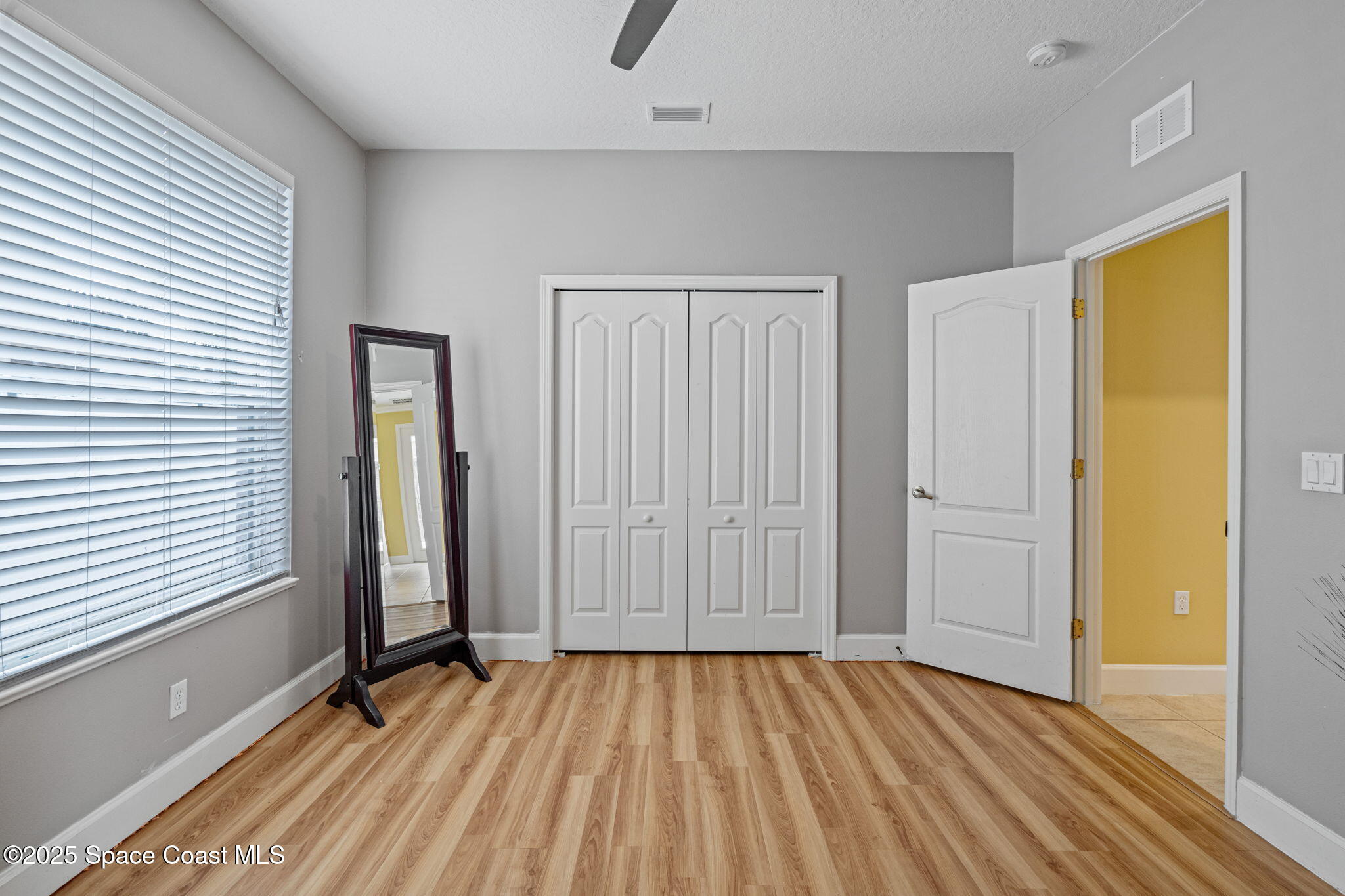 1835 Harbor Point Drive Merritt Island, FL 32952 - Photo 38 of 67 an empty room with wooden floor and windows