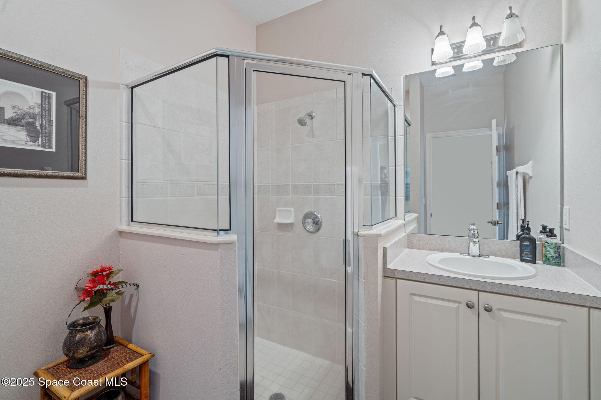 1835 Harbor Point Drive Merritt Island, FL 32952 - Photo 39 of 67 a bathroom with a shower a sink and a mirror