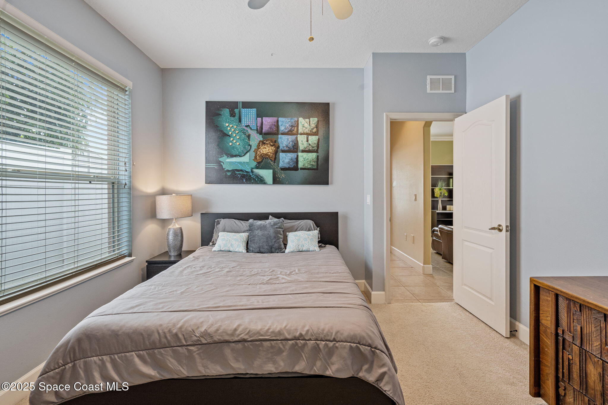 1835 Harbor Point Drive Merritt Island, FL 32952 - Photo 43 of 67 a bedroom with a bed and a painting on the wall