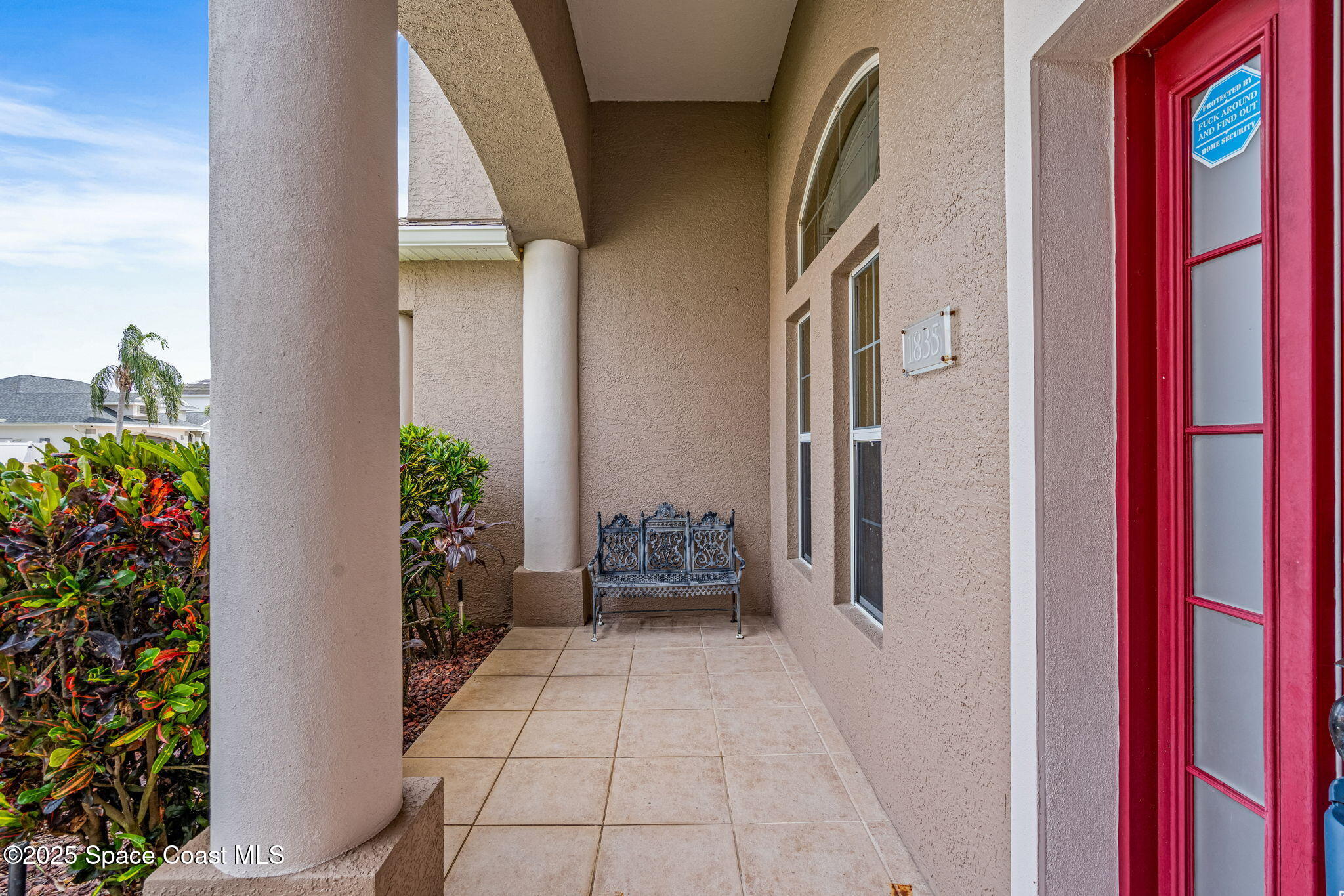 1835 Harbor Point Drive Merritt Island, FL 32952 - Photo 5 of 67 a balcony with potted plants and wooden floor