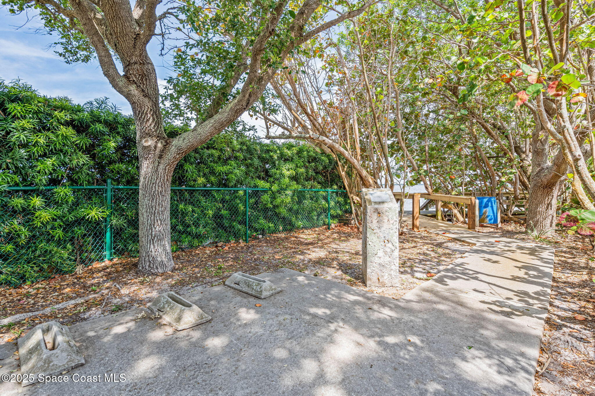 1835 Harbor Point Drive Merritt Island, FL 32952 - Photo 53 of 67 a view of a tree in front of a white house