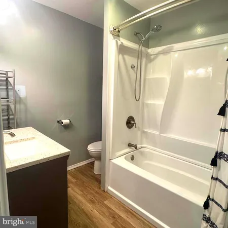a bathroom with a bathtub a sink and a shower