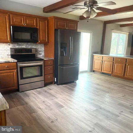 a kitchen with a refrigerator an oven a sink and dishwasher