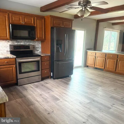 a kitchen with a refrigerator an oven a sink and dishwasher