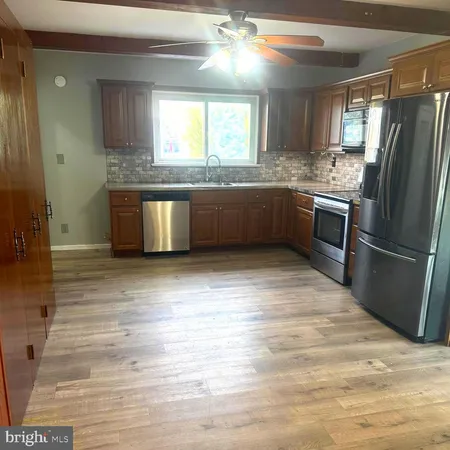 a kitchen with granite countertop a refrigerator and a sink
