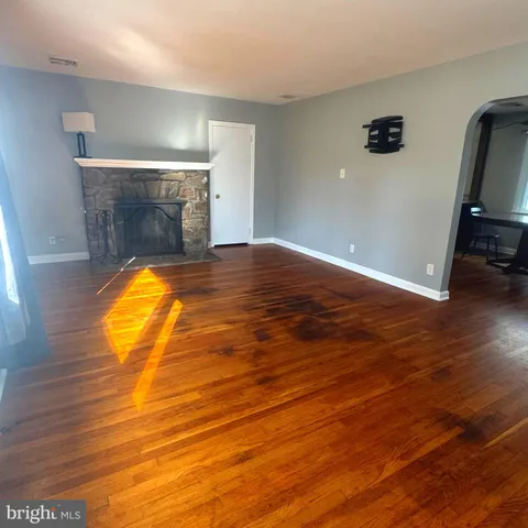a view of a room with wooden floor and a sink