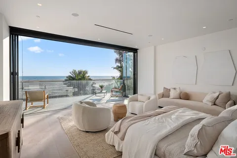 a living room with furniture large windows and a flat screen tv