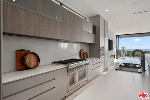 a kitchen with stainless steel appliances granite countertop a stove and a refrigerator