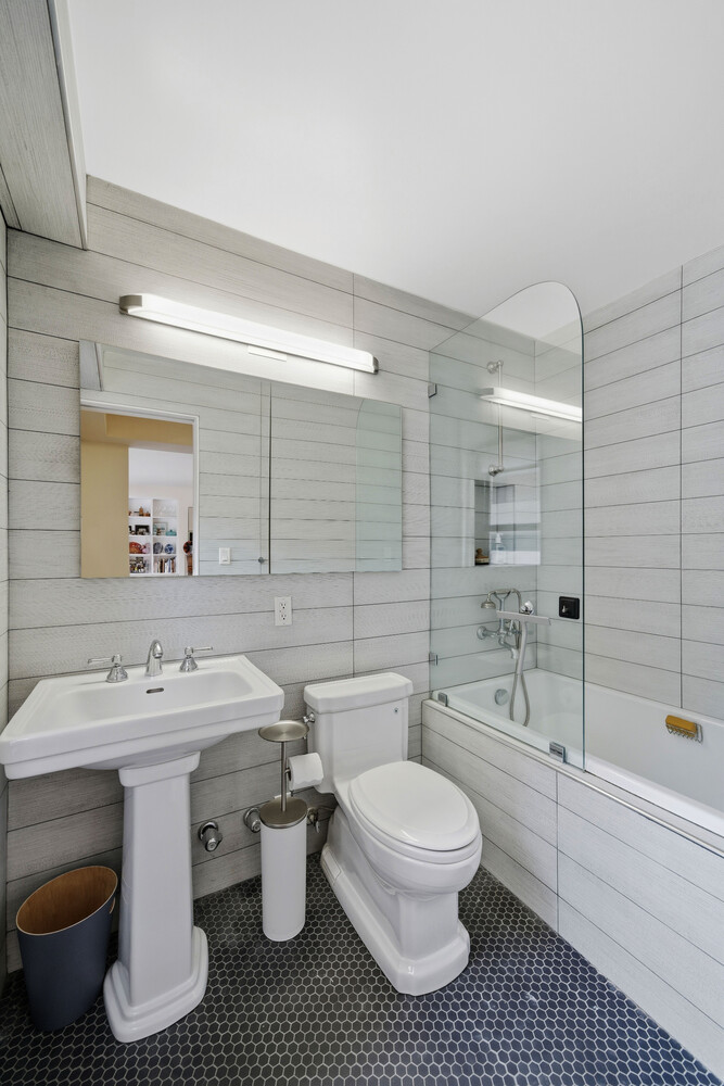 1065 Park Avenue, Unit 3C Manhattan, NY 10128 - Photo 7 of 8 a bathroom with a sink toilet and shower