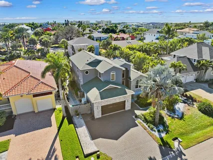 an aerial view of a house with a yard