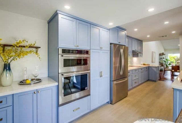 a kitchen with granite countertop a sink a stove and wooden cabinets