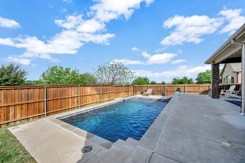a view of swimming pool with a patio