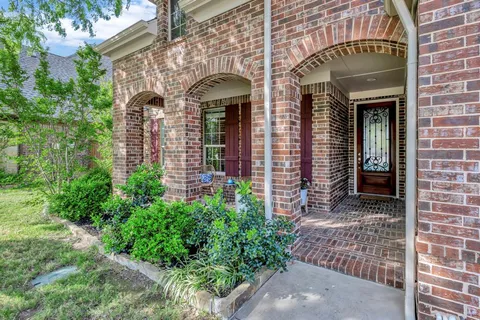 front view of a brick house with a large windows