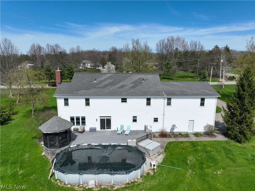 9900 Mentor Road Chardon, OH 44024 - Photo 46 of 49 Back of house featuring a patio area, a lawn, and a covered pool