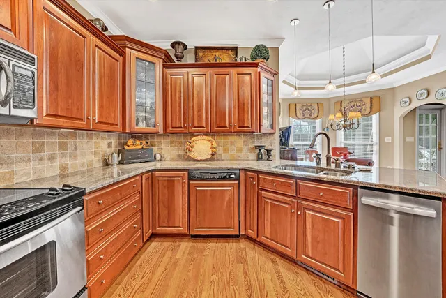 a kitchen with cabinets appliances and a counter top space