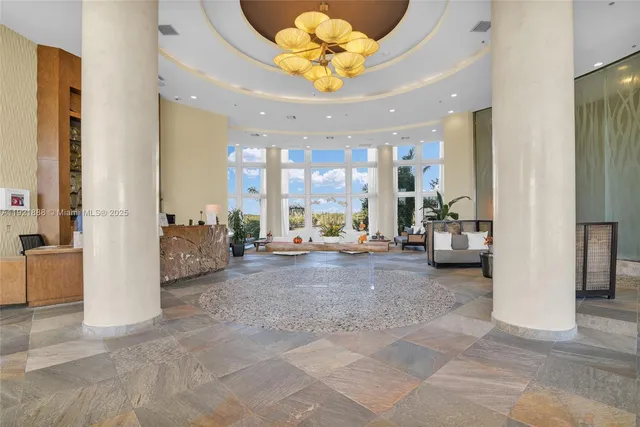 a very nice looking room with a large window and chairs