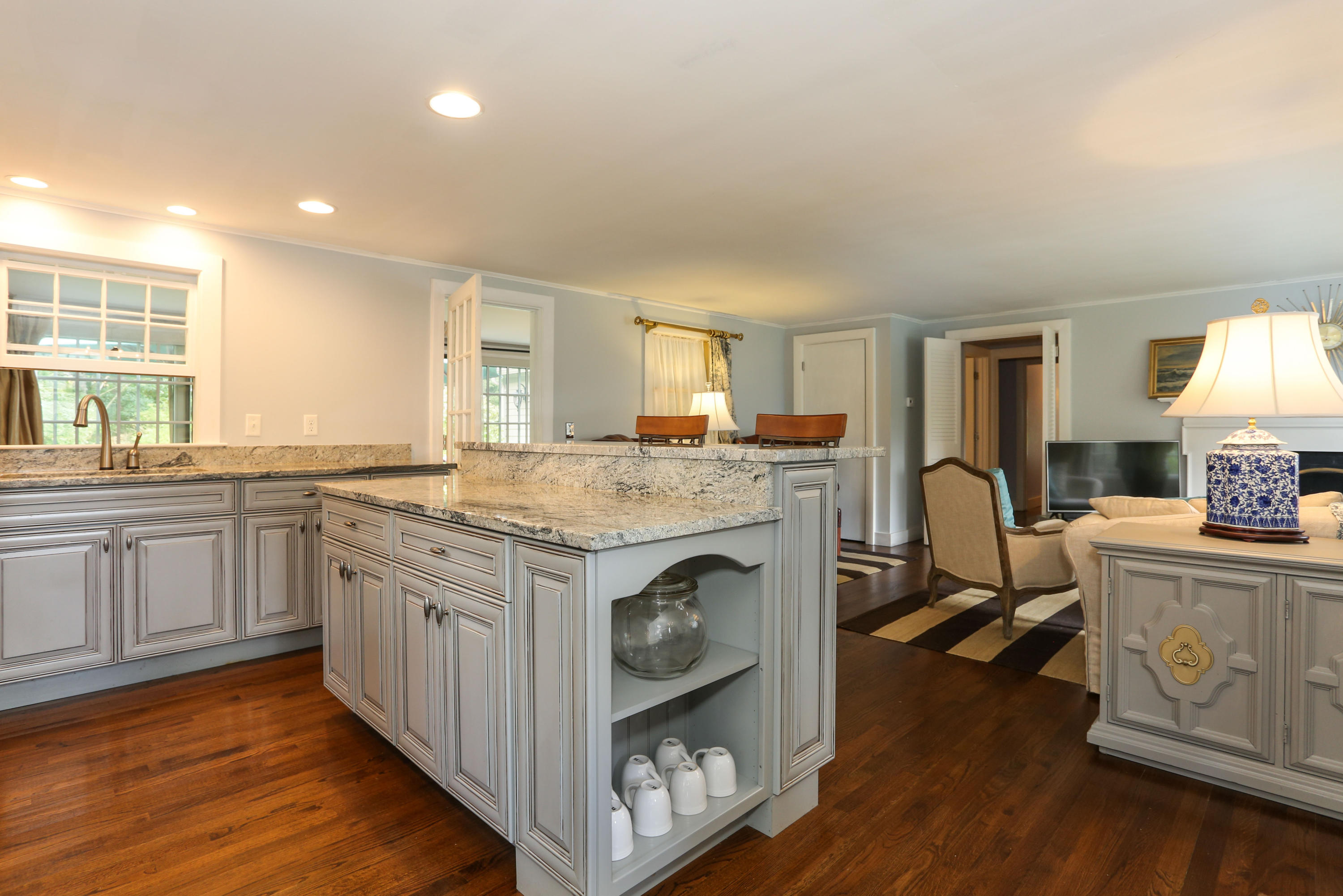 18 Sparrowhawk Road Orleans, MA 02653 - Photo 12 of 43 a kitchen with granite countertop a sink cabinets and wooden floor