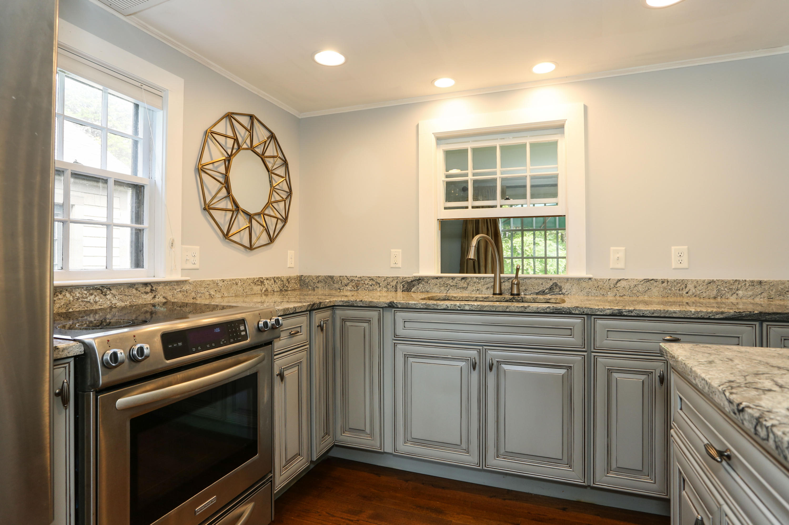 18 Sparrowhawk Road Orleans, MA 02653 - Photo 14 of 43 a kitchen with stainless steel appliances granite countertop a stove and a sink