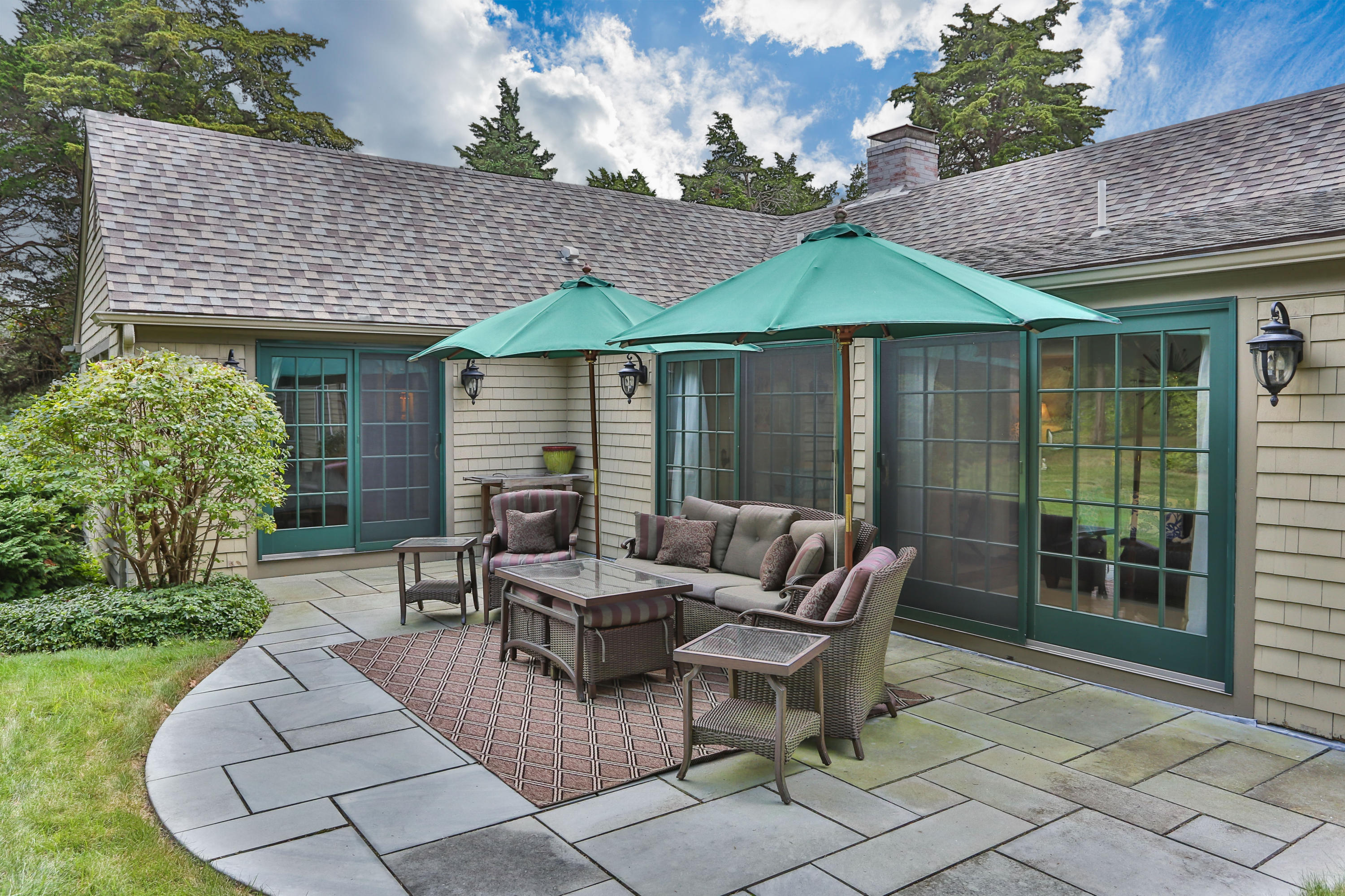 18 Sparrowhawk Road Orleans, MA 02653 - Photo 5 of 43 a patio with couches table and chairs and potted plants