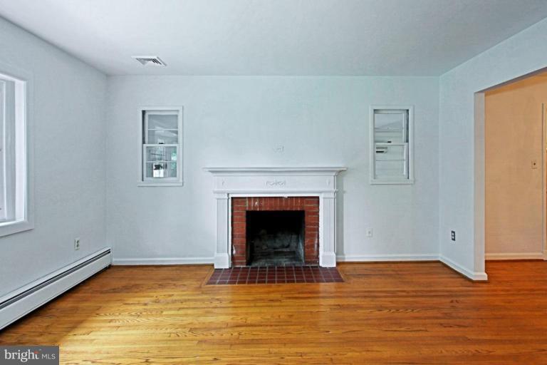 821 Snider Lane Silver Spring, MD 20905 - Photo 6 of 26 Living Room w wood floors and wood burn fireplace