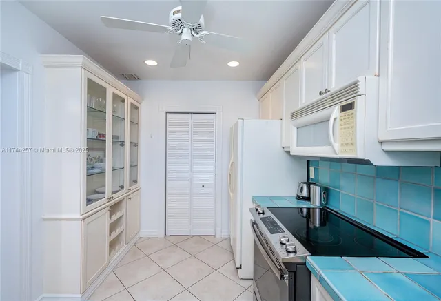 a kitchen with stainless steel appliances granite countertop a sink and a refrigerator