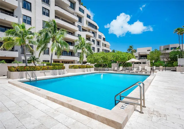 a swimming pool with outdoor seating and yard