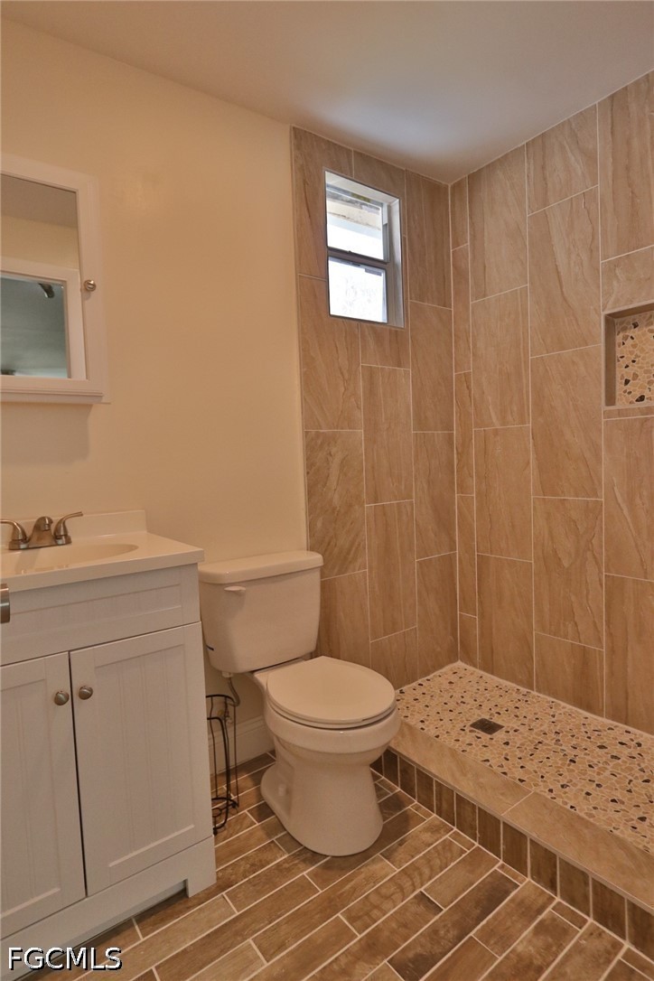 11 California Road Lehigh Acres, FL 33936 - Photo 11 of 19 a bathroom with a sink a toilet and a shower