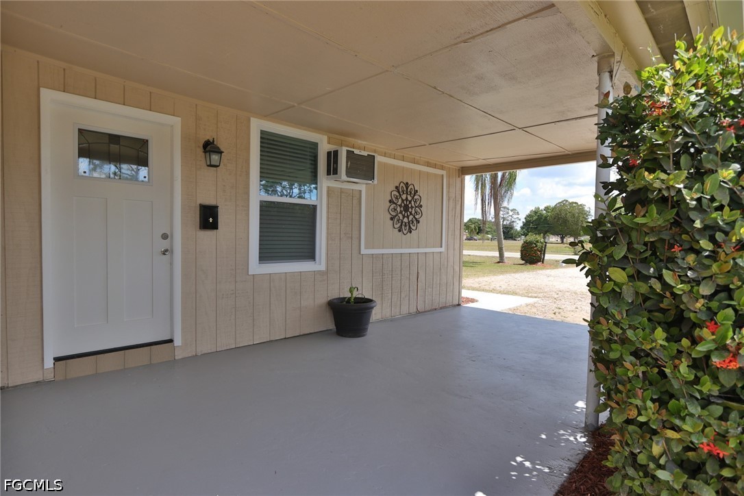 11 California Road Lehigh Acres, FL 33936 - Photo 3 of 19 a view of an empty room with a window