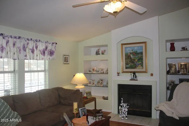 a view of a livingroom with furniture and a window