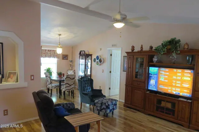 a living room with furniture a chandelier and a window