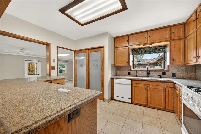 a kitchen with stainless steel appliances granite countertop a stove a sink and a microwave