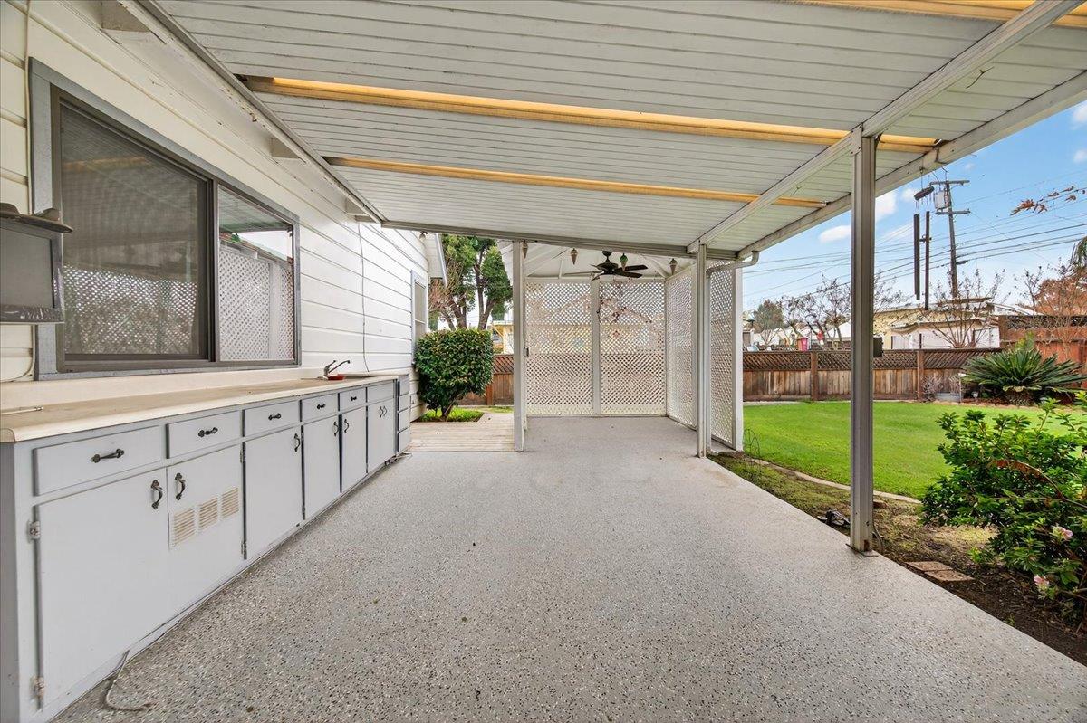 311 South K Street Madera, CA 93637 - Photo 18 of 46 a view of a porch with wooden floor and fence