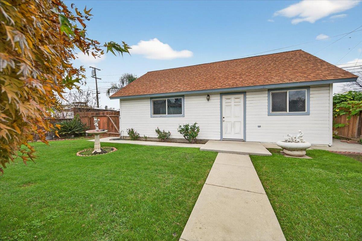 311 South K Street Madera, CA 93637 - Photo 20 of 46 a front view of house with yard