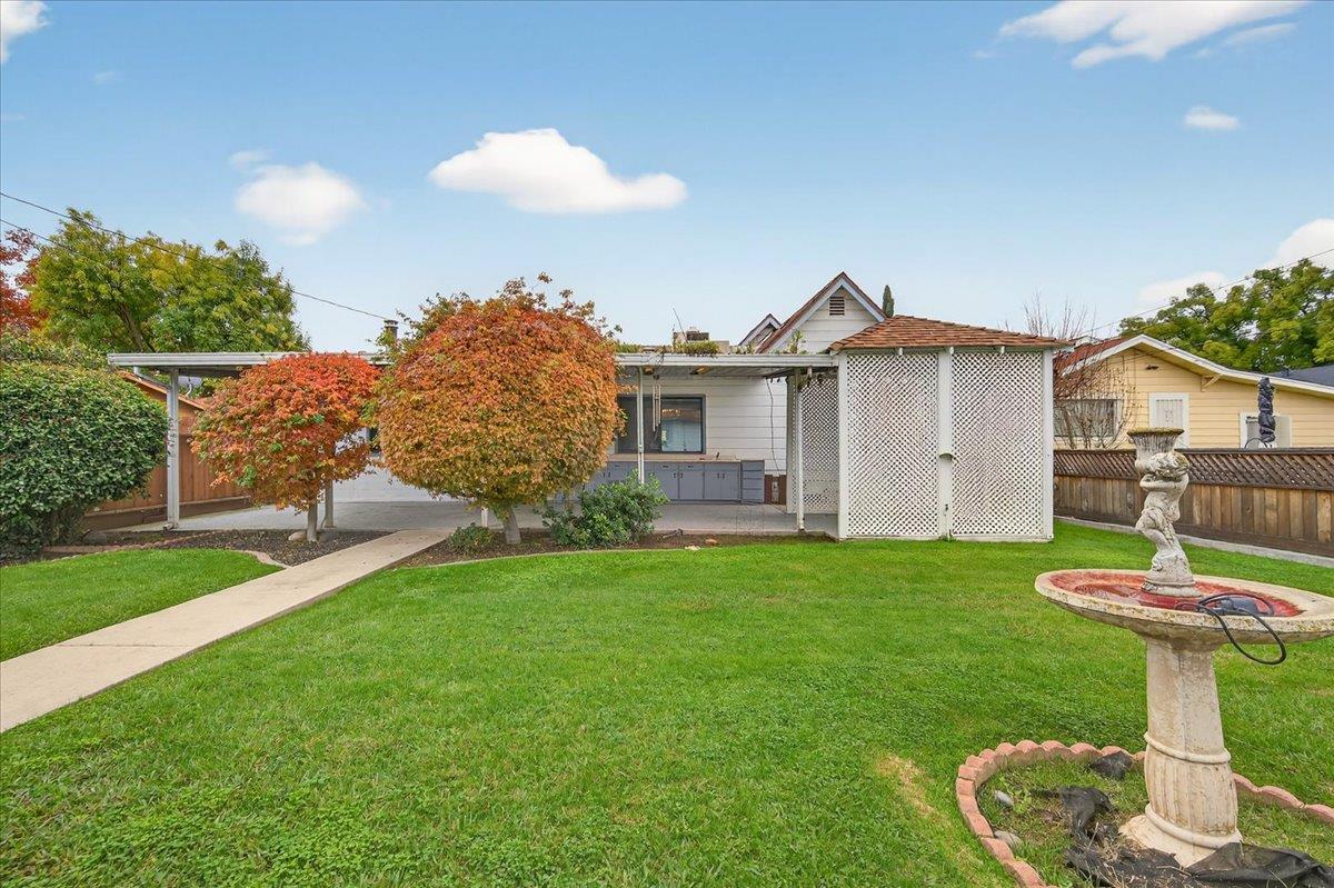 311 South K Street Madera, CA 93637 - Photo 23 of 46 a view of a house with a yard and a garden