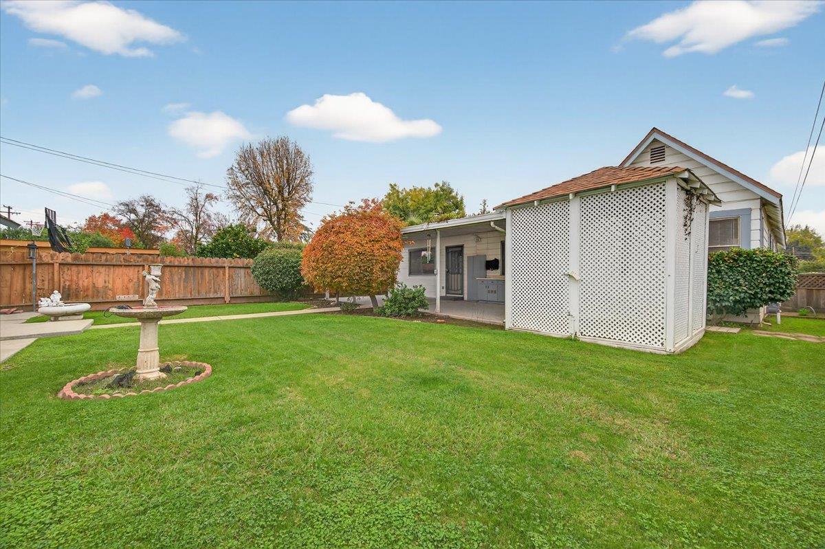 311 South K Street Madera, CA 93637 - Photo 24 of 46 a view of a house with a yard