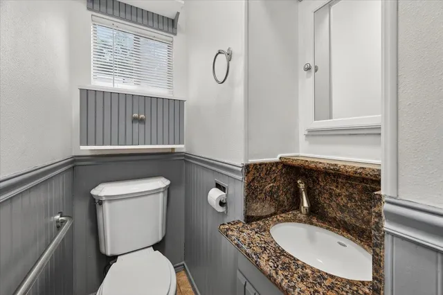 a view of an empty room with a window and dresser