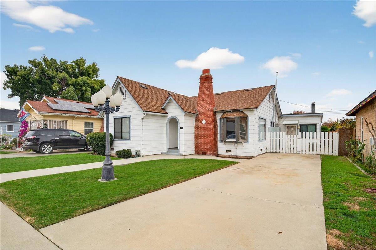311 South K Street Madera, CA 93637 - Photo 30 of 46 a front view of a house with a yard and porch