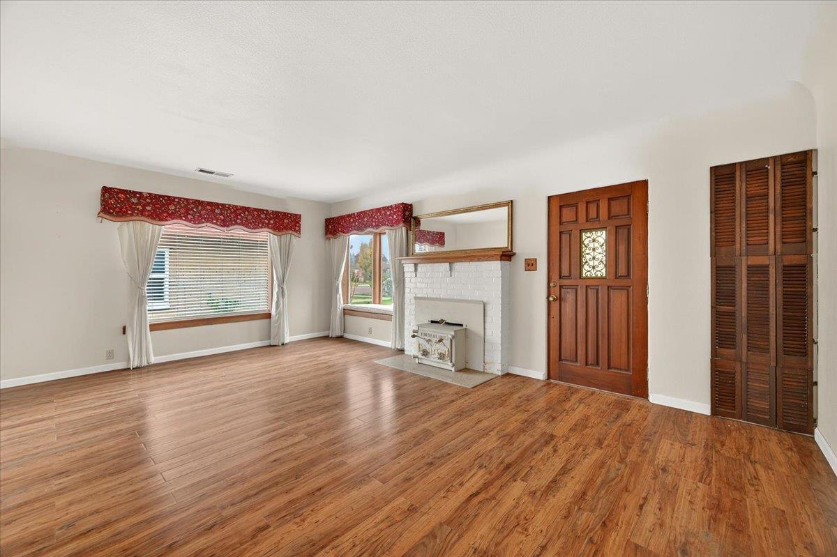 311 South K Street Madera, CA 93637 - Photo 32 of 46 a view of an empty room with a window and fireplace