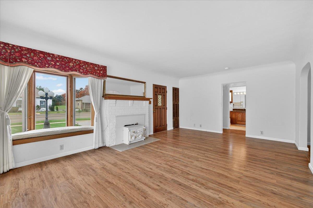 311 South K Street Madera, CA 93637 - Photo 33 of 46 a view of an empty room with a window and wooden floor