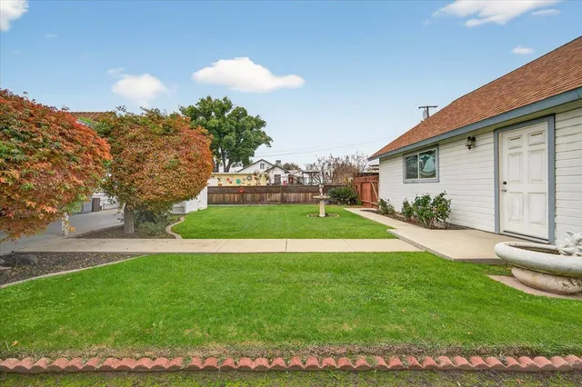 a view of a house with a yard and a garden
