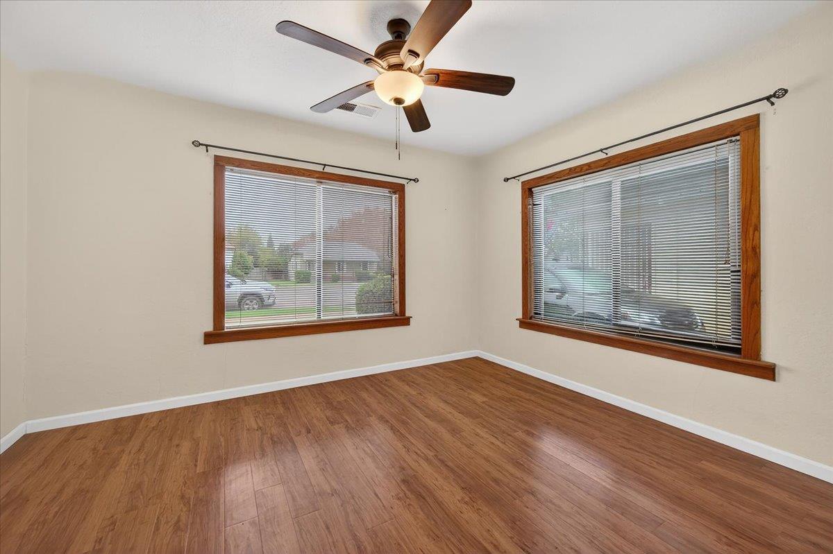 311 South K Street Madera, CA 93637 - Photo 42 of 46 a view of an empty room with a window and a painting on the wall