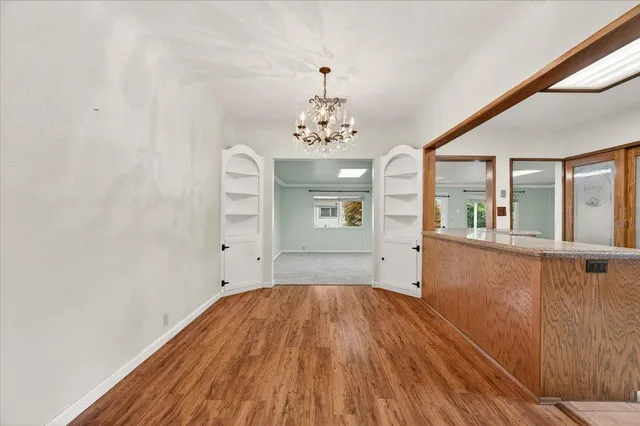 a view of a room with wooden floor and windows