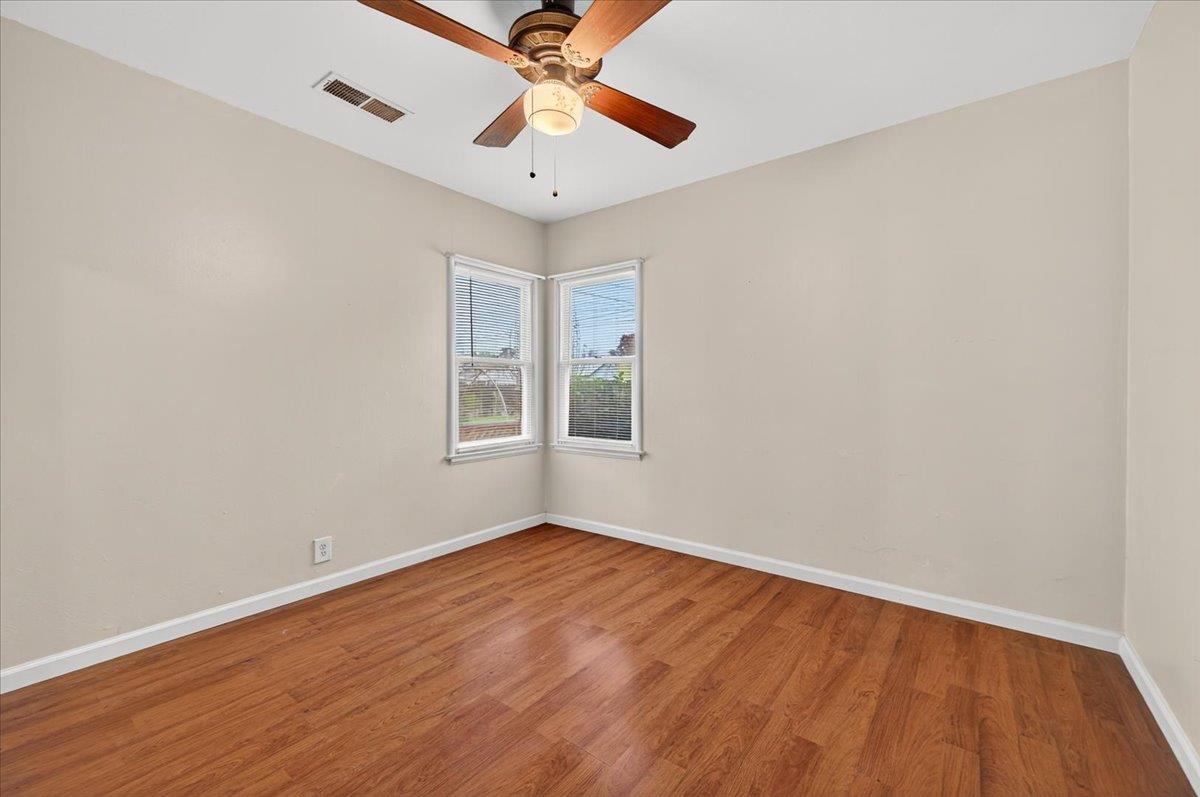 311 South K Street Madera, CA 93637 - Photo 10 of 46 wooden floor in an empty room with a window