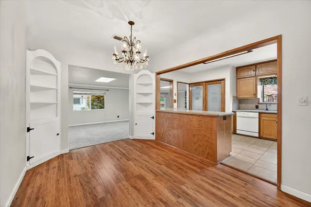 a view of a kitchen with wooden floor and a kitchen