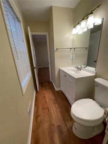 a bathroom with a sink and mirror with toilet