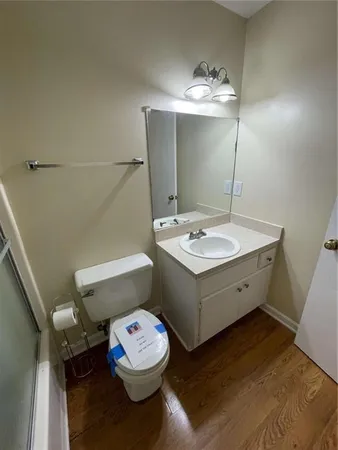 a bathroom with a sink a toilet and a mirror